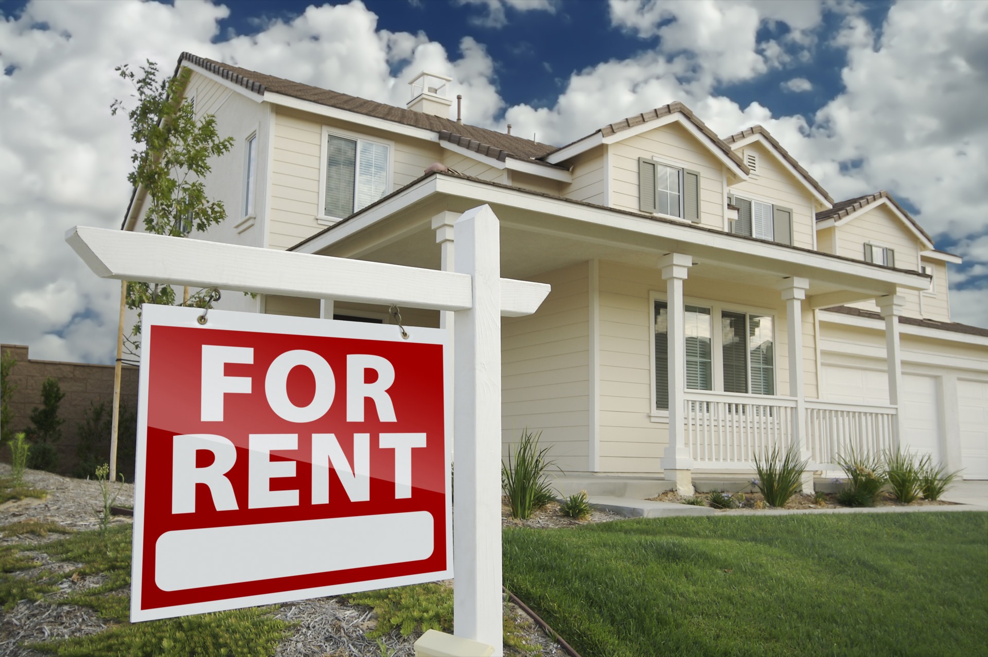Single-family home with a For Rent sign in the front yard